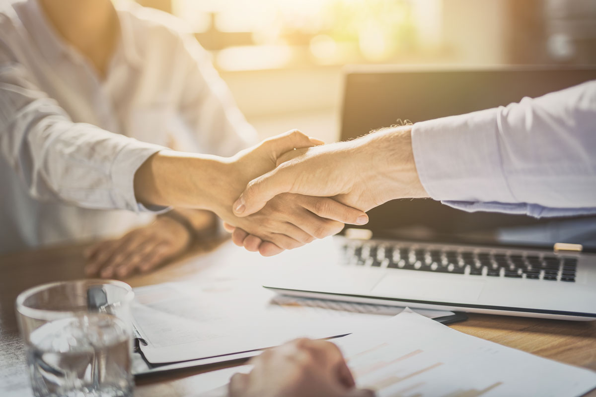 employer shaking hands with employee with a group benefit plans in Harlingen