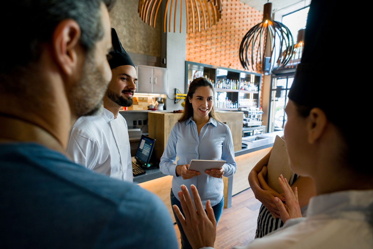 Employees sitting with a boss reviewing group benefits plans